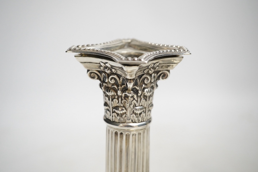 A pair of Edwardian dwarf Corinthian column silver candlesticks, by Harrison Brothers and Howson, Sheffield 1908 (loaded), 15.5cm high and a Victorian silver pedestal sugar bowl by Jacobes J Oosterbaan, London 1878, 148g